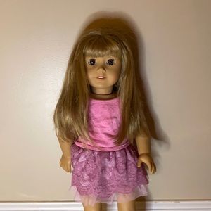 American girl doll with the pink outfit